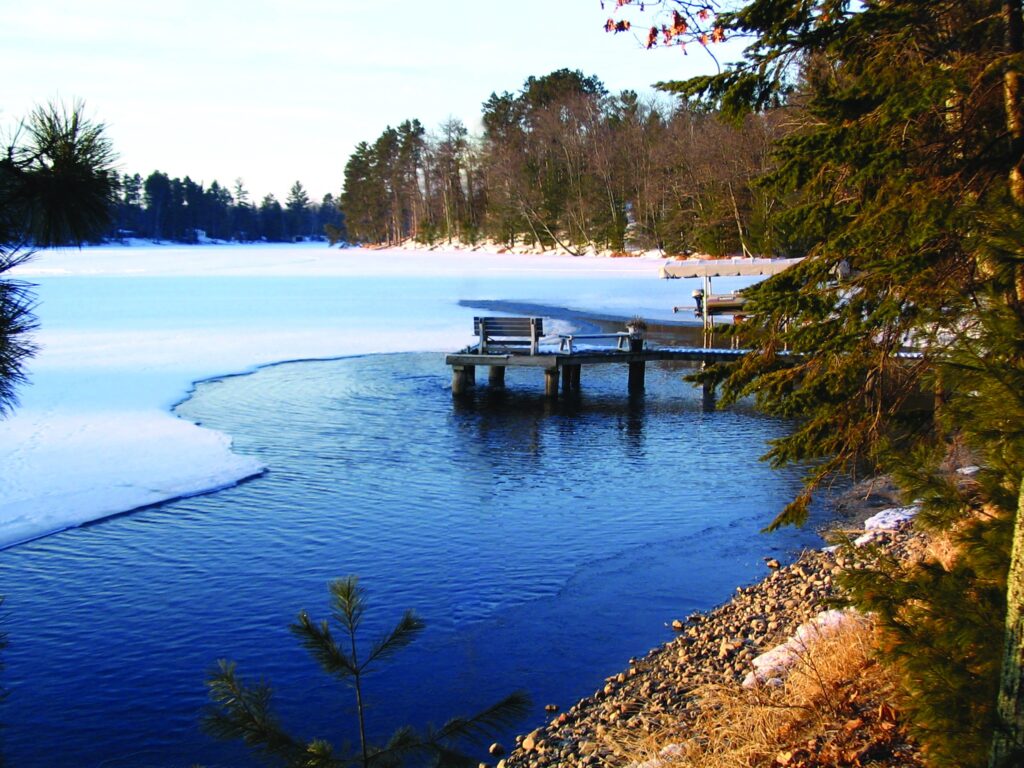A dock in the winter with a deicer active, preventing ice buildup